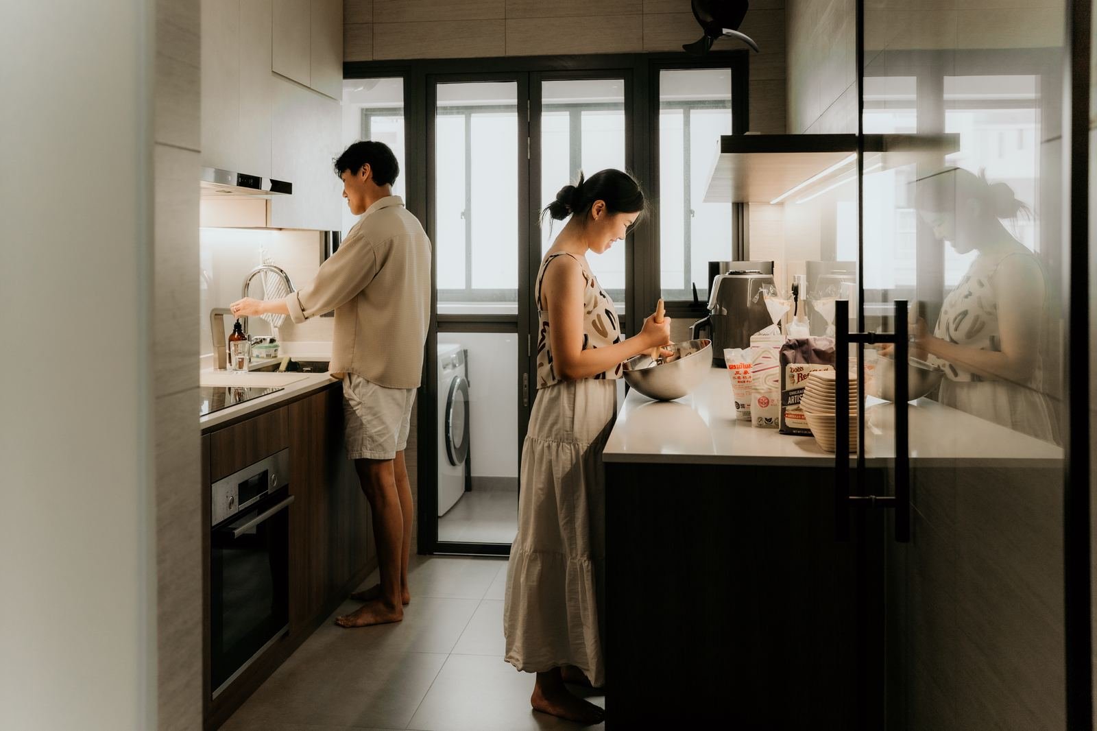 Couple preparing bakes together in their galley kitchen